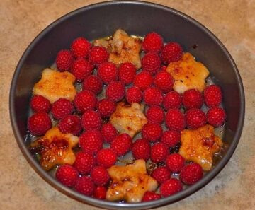 star shaped sauteed pears and raspberries in a buttered pan