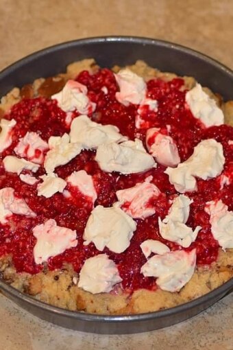 red berry mixture and mascarpone cheese layered over panettone cubes in a pan