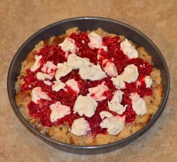red berry mixture and mascarpone cheese layered over panettone cubes in a pan
