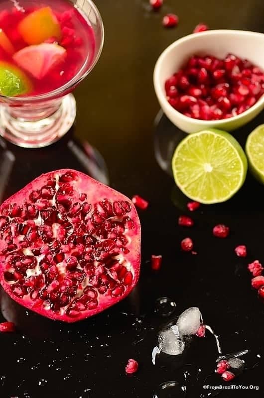 Pomegrantes and a lime on a table as good luck ingredients for one of our New Year's Eve Cocktails.