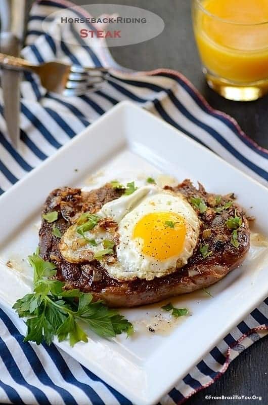 Grilled steak on a white plate, with a fried egg on top.