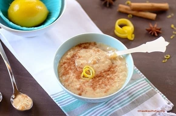 Blue bowl of arroz doce com leite condensado or creamy Brazilian Rice Pudding topped with cinnamon