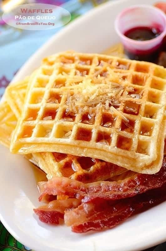 gluten-Free waffles topped with maple syrup and a side of bacon and jam