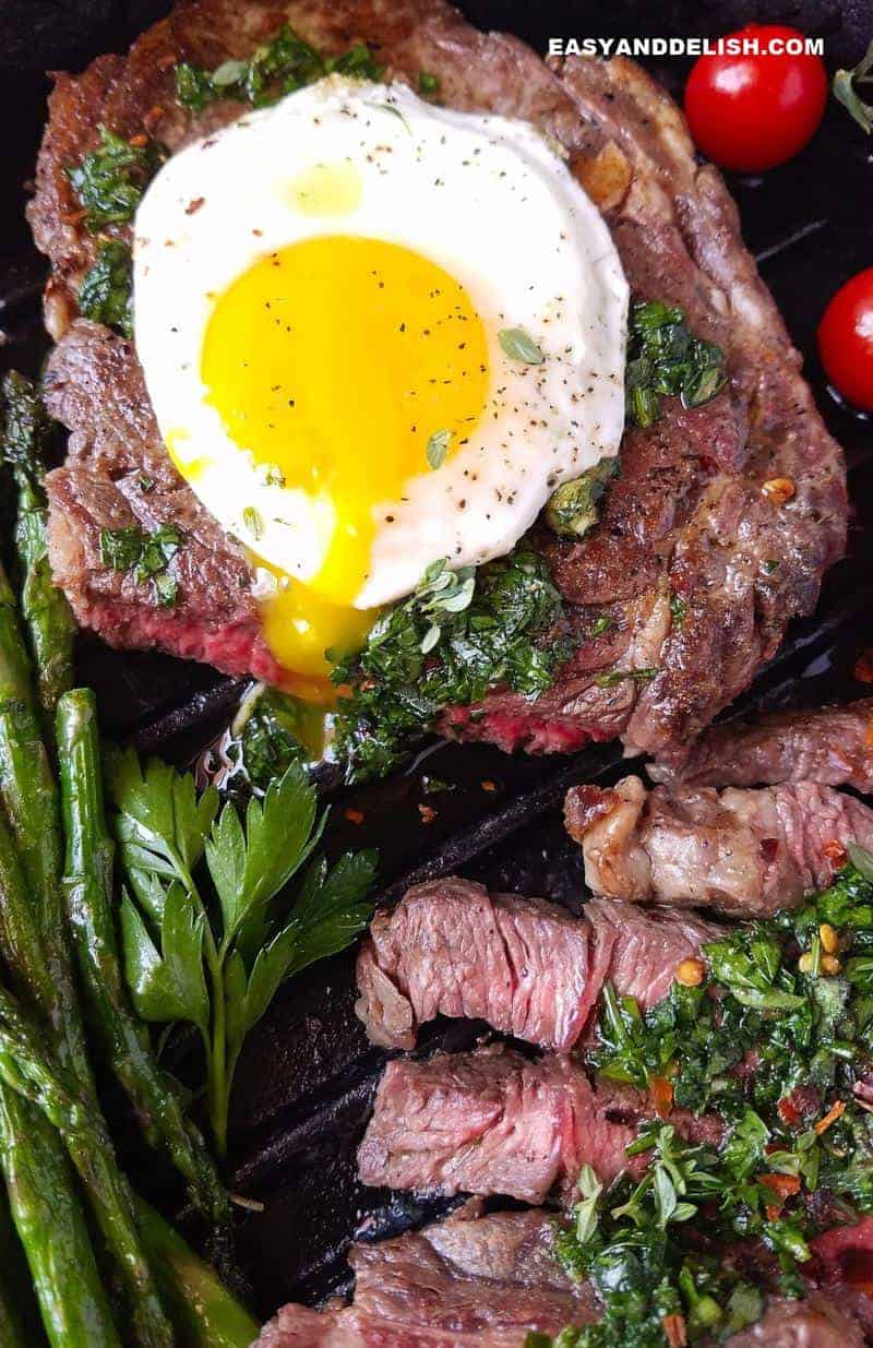 close up of runny egg yolk over a steak