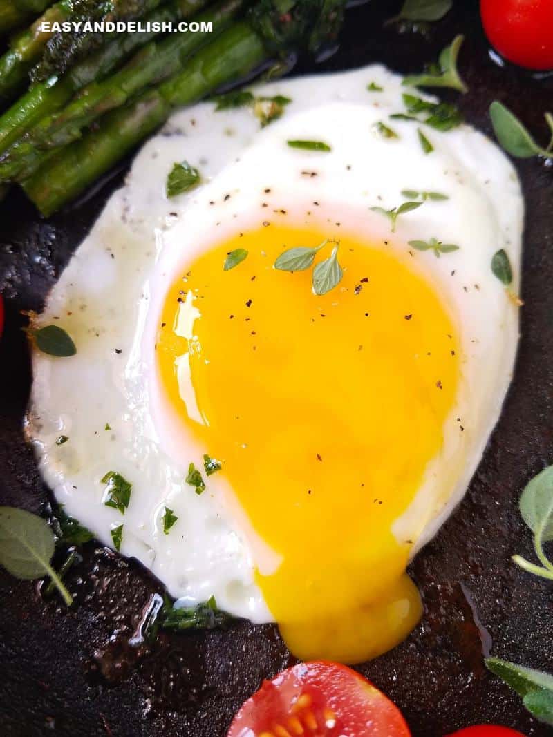 A runny egg in a skillet.