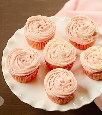 Several Passion Fruit Mousse Cupcakes on a frilled serving dish