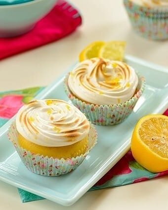 lemon meringue cupcakes in a platter with garnishes on the side