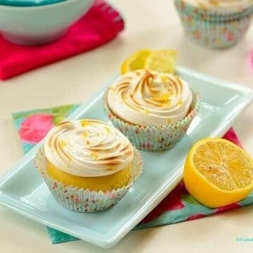lemon meringue cupcakes in a platter with garnishes on the side