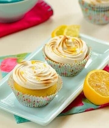 lemon meringue cupcakes in a platter with garnishes on the side