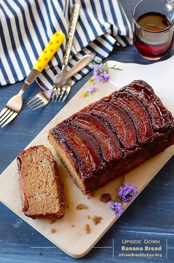 Upside Down Banana Bread served on a platter with a cup of coffee on the side