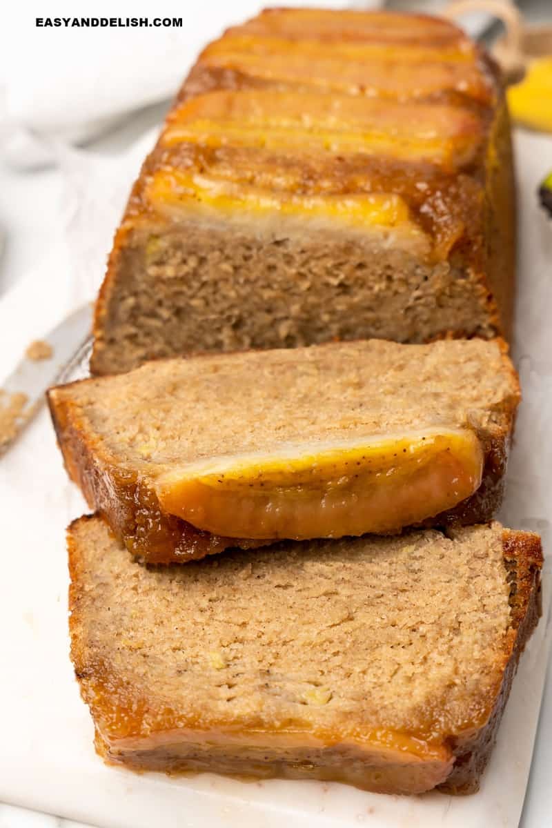 a baked good partially sliced on a cutting board