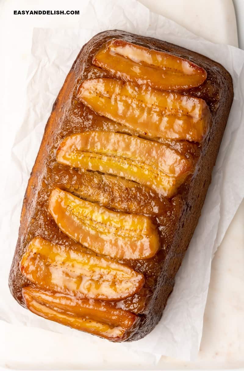whole caramelized banana bread on a cutting board