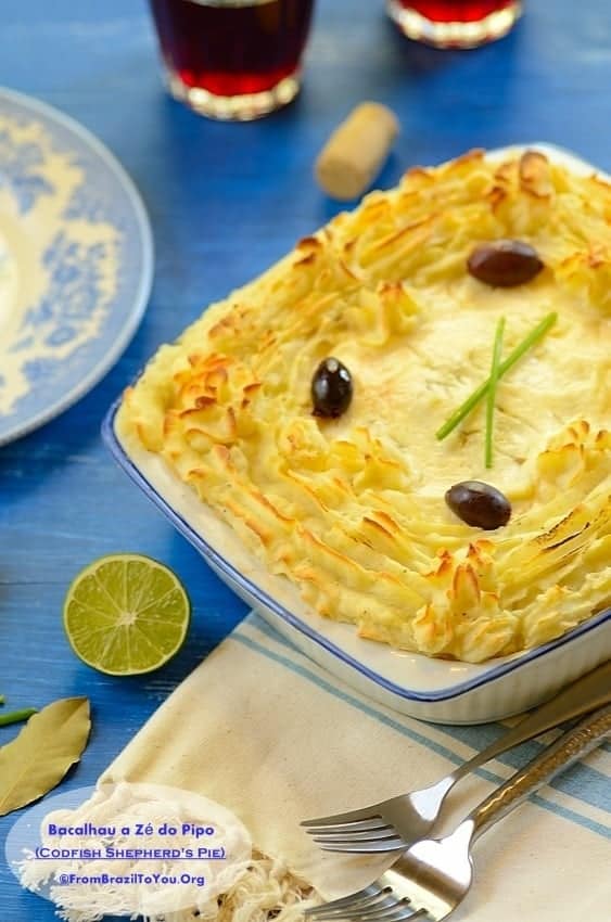 Fish pie ina  baking dish topped with black olives and garnishes around it