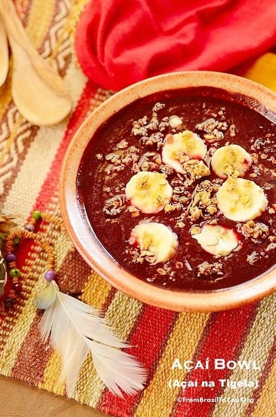 Traditional acai bowl fruit smoothie from the Amazon, topped with bananas and granola