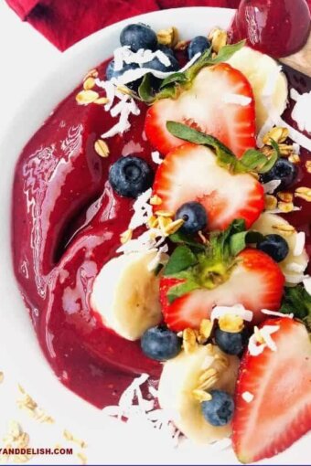 close up of acai bowl topped with fresh fruits