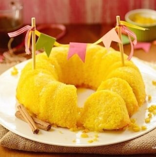sliced sweet corn cake in a platter decorated with a cake banner
