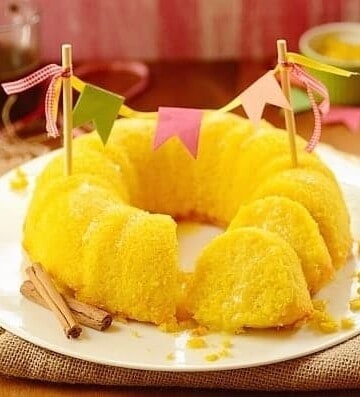 sliced sweet corn cake in a platter decorated with a cake banner