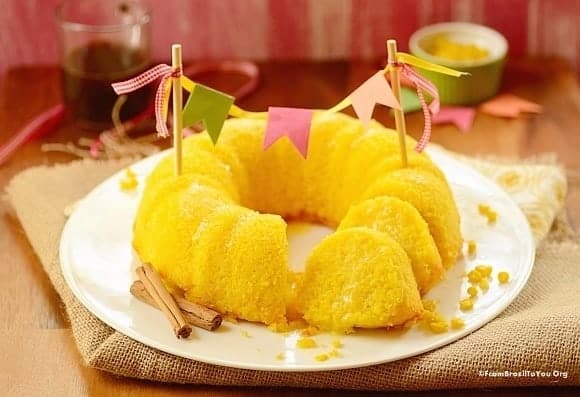 sliced sweet corn cake in a platter decorated with a cake banner