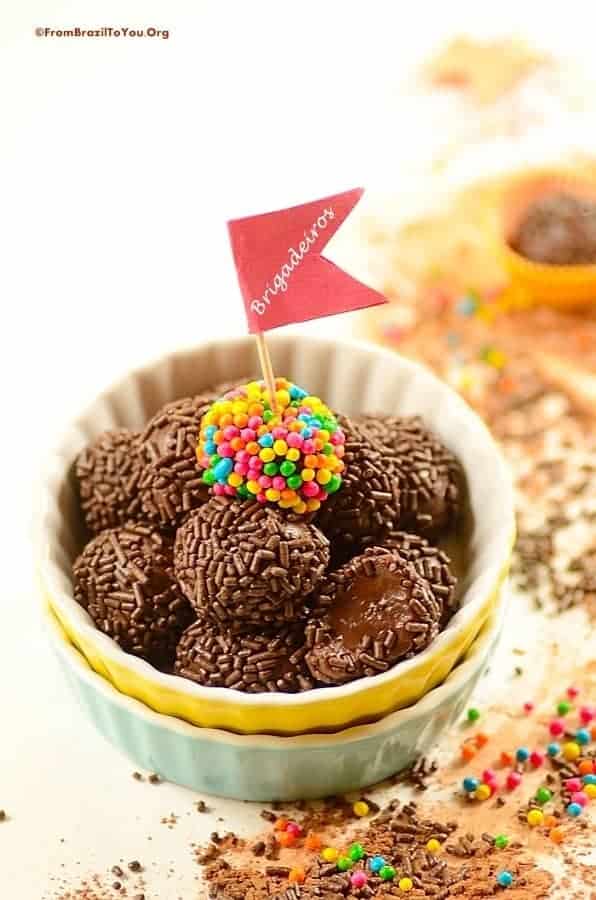 brigadeiro candies in a bowl with a little flag