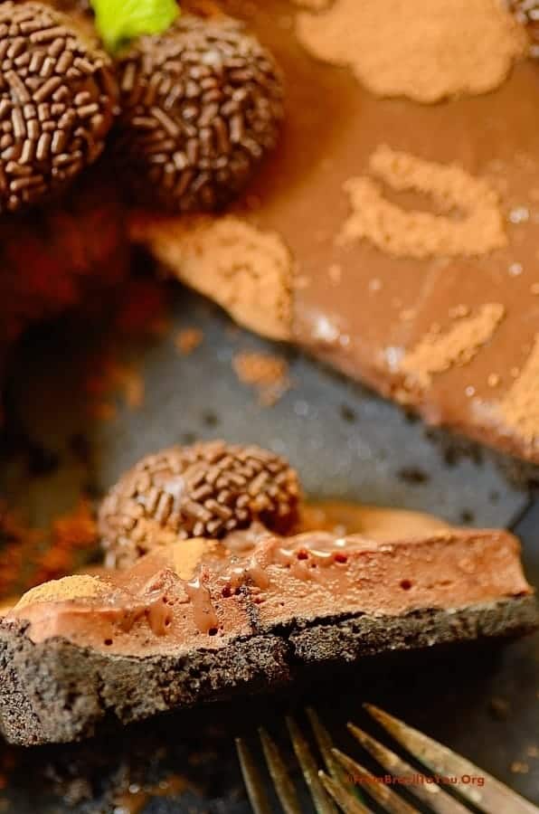 Triple Brigadeiro Cheesecake Tart image showing a slice half way up