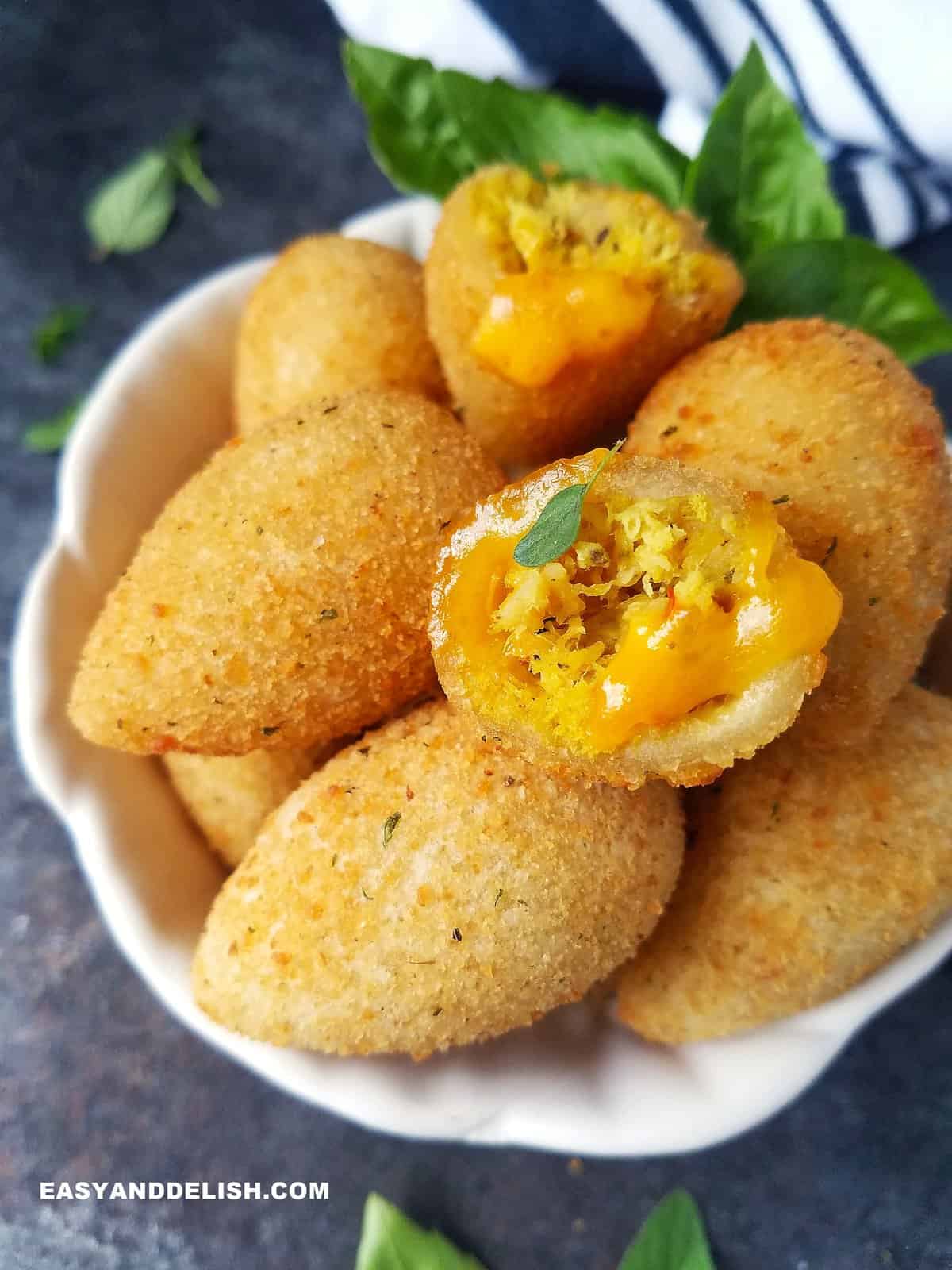 Brazilian chicken croquettes served in a bowl with some herbs