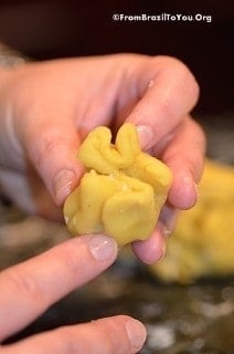 coxinha dough is being formed into a drumstick shape and at this point is shaped like a beggar's purse