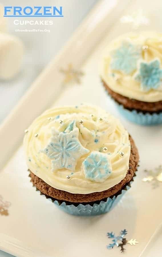 Two frosted cupcakes with snowflake decorations