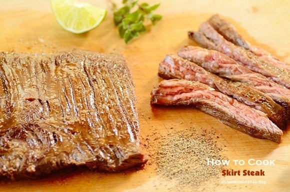 whole and sliced skirt steak on a board