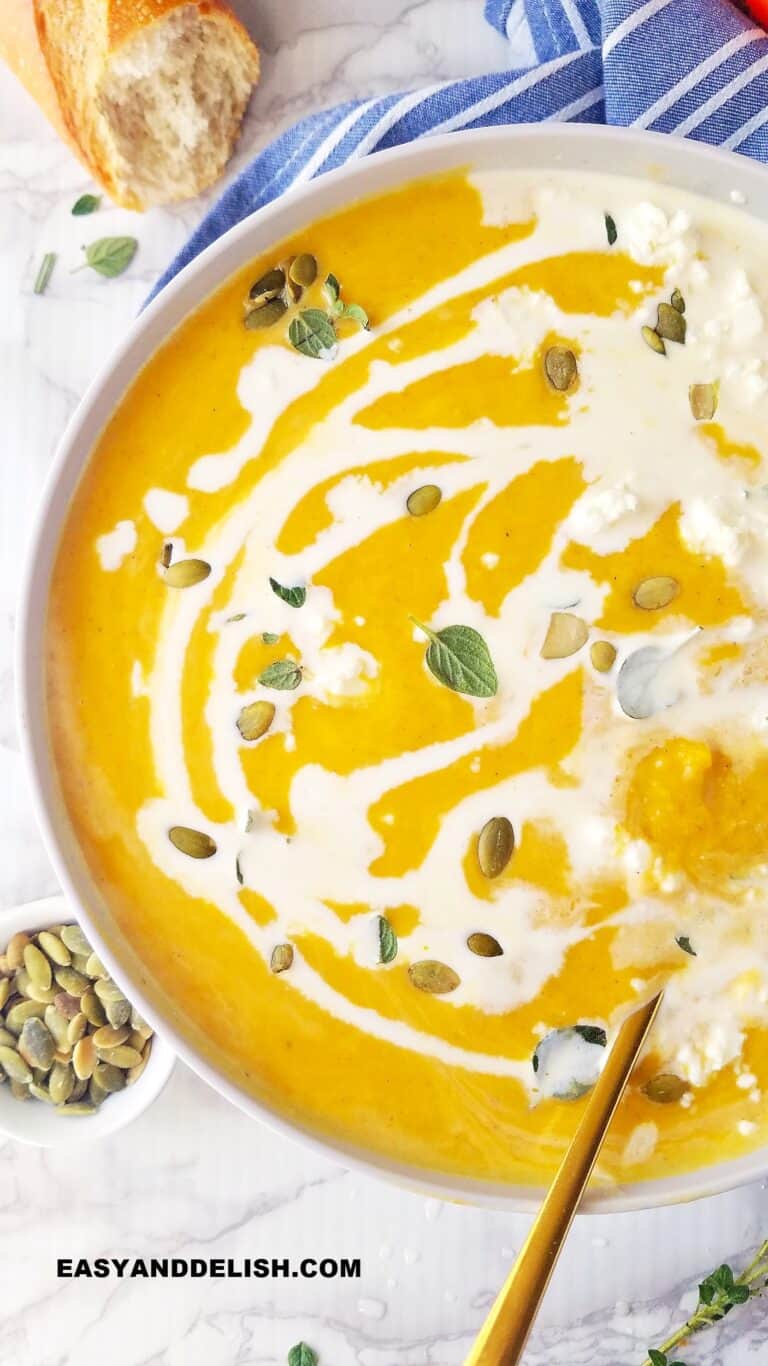 close up of a bowl of vegan pumpkin soup drizzled with coconut milk