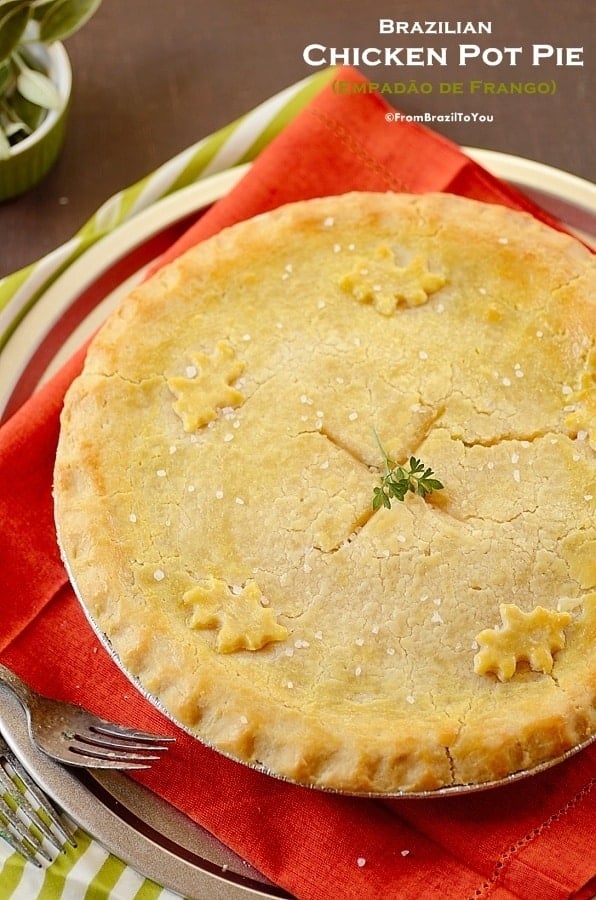 Empadão brazilian chicken pot pie in a pie tin on a red cloth