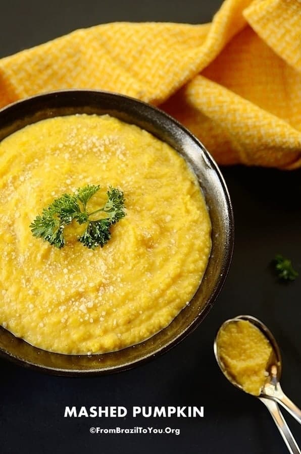 mashed pumpkin in a bowl with spoon on teh side