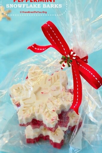 Peppermint snowflake barks wrapped in clear wrapper and tied with a red bow