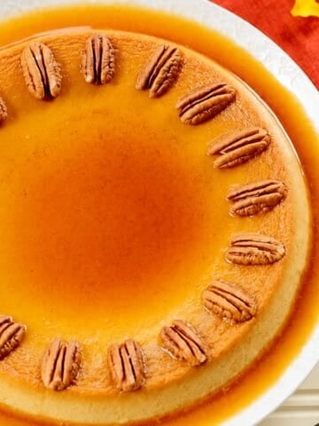 Pumpkin custard topped with roasted pecans and surrounded by caramel sauce.