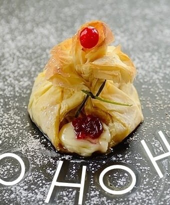 Santa's Breakfast pouch pastry on a board with the words "Ho Ho Ho" written