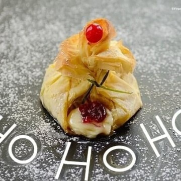 Santa's Breakfast pouch pastry on a board with the words "Ho Ho Ho" written