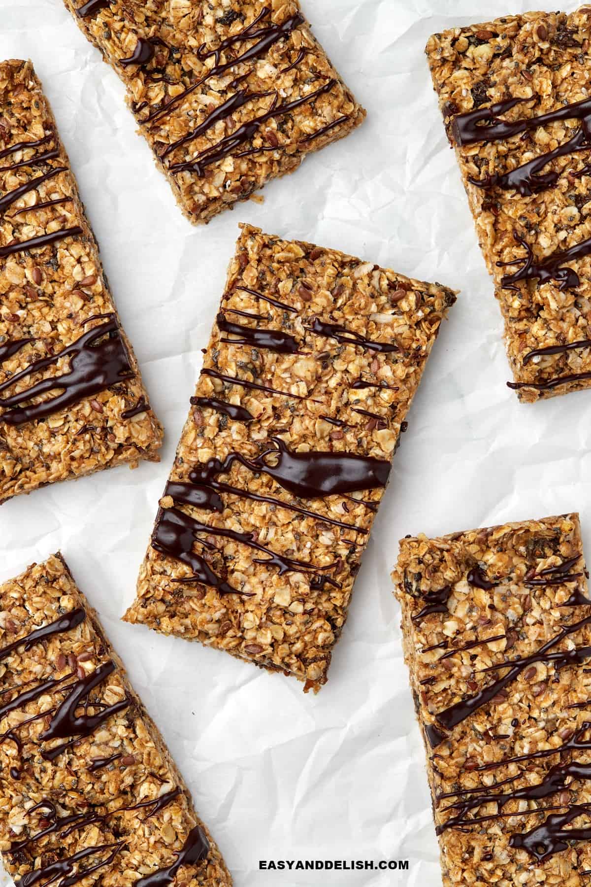 a bunch of no bake snack treats drizzled with chocolate.