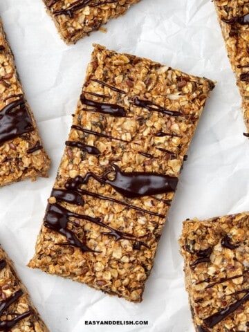 Close up of homemade energy bars drizzled with melted chocolate.