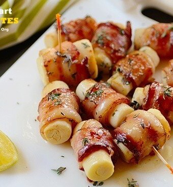 A tray of hearts of palm on skewers wrapped with bacon