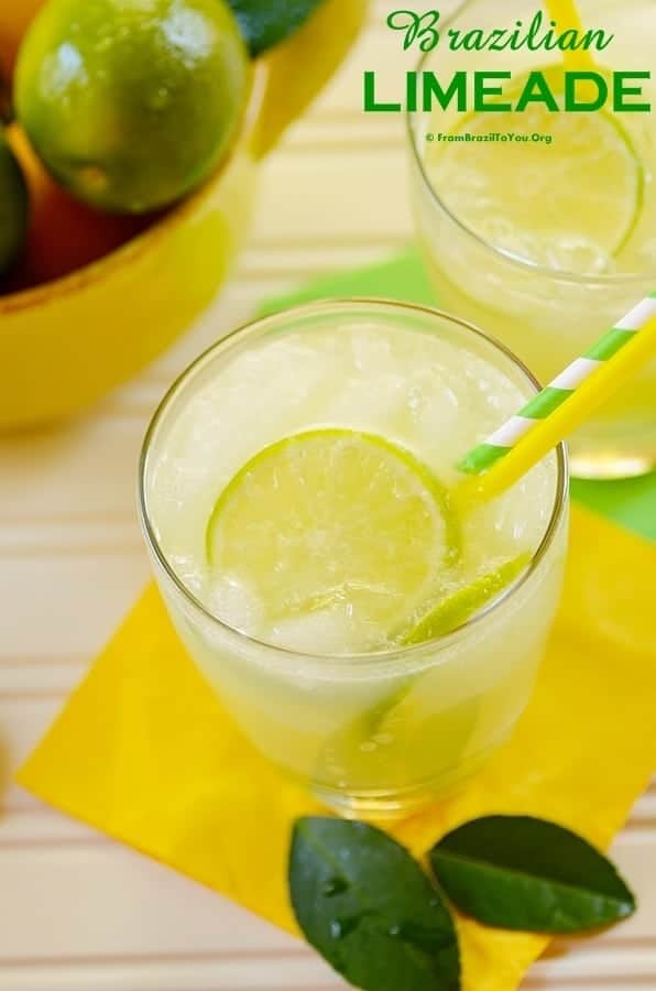 A close up of a glass of limeade with a straw