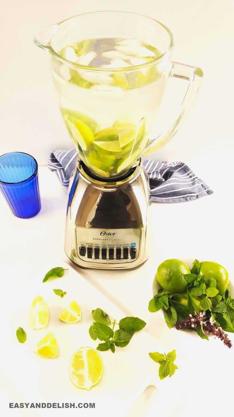 limes with sugar, water, and ice in a blender.