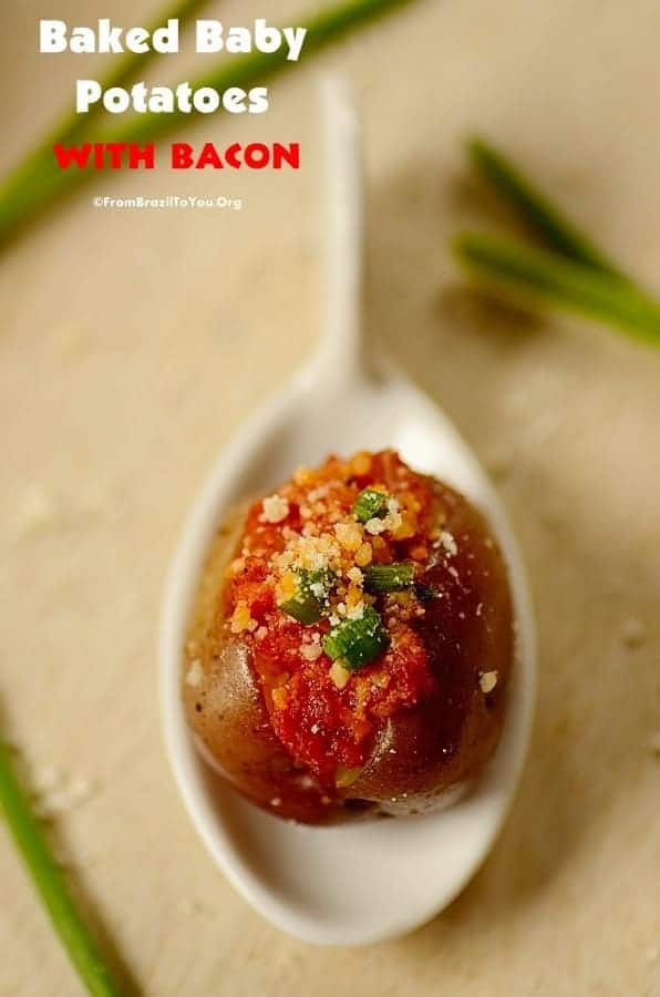 A close up of baked baby potatoes with bacon served in a white serving spoon