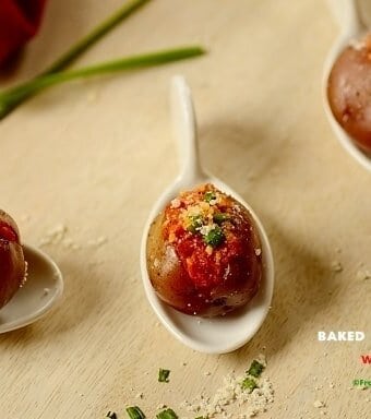 Baked baby potatoes with bacon on a table