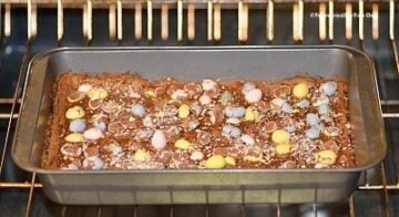 Easter mini egg cookie bars being baked in a pan