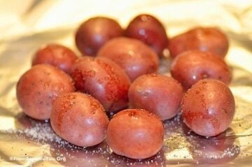 baby potatoes on aluminum foil, sprinkled with salt