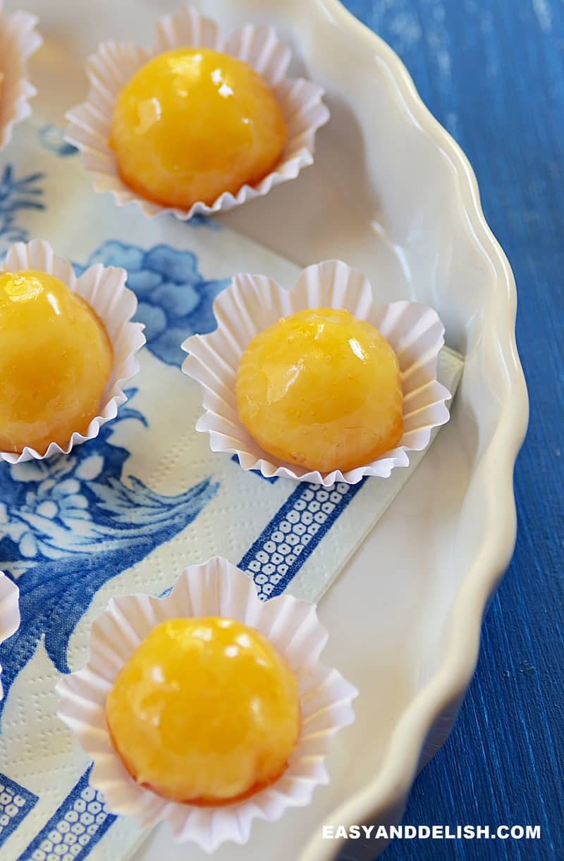 several coconut bon bons with hard caramel shell served in a party tray