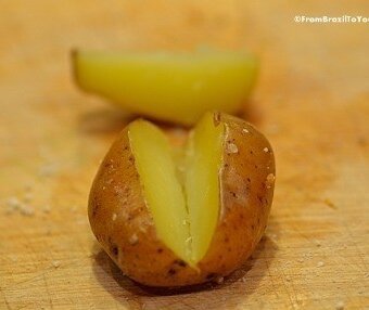 cooked baby potato with a wedge cut into it