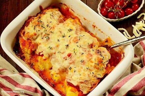 stuffed and baked chicken parmesan in a baking dish