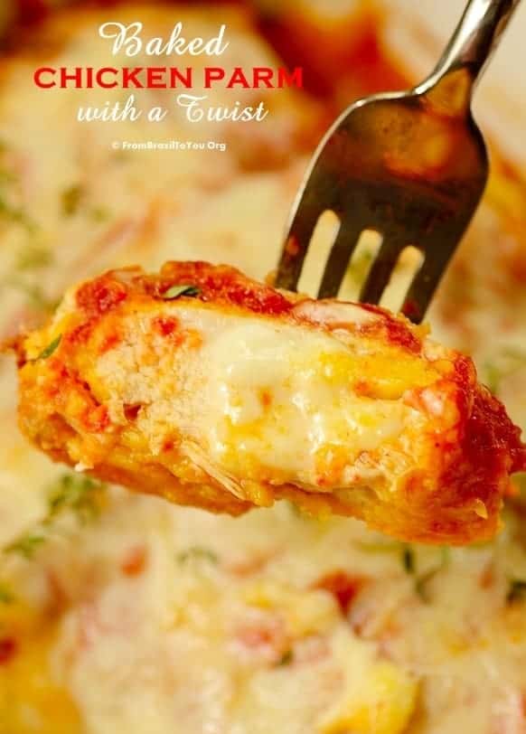 baked chicken parmesan sliced, showing cheesy center and held with a fork
