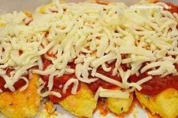 A close up of chicken with sauce and cheese