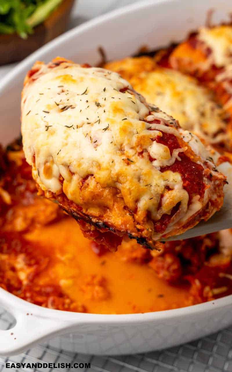 a breast of gluten-free chicken parmesan lifted with a spatula